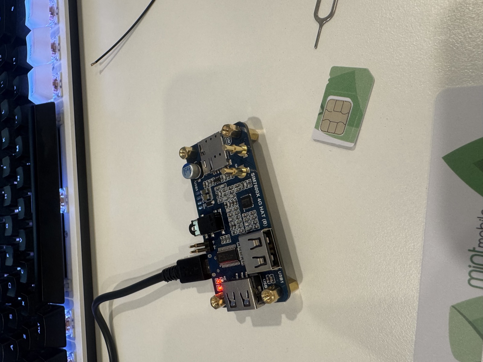 A SIM7600X 4G modem board with a SIM card on a desk